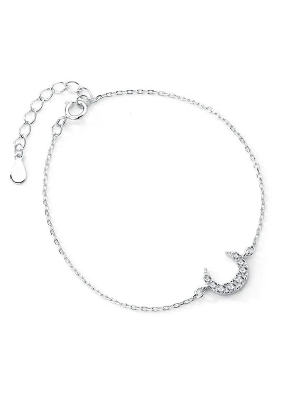 Silver bracelet with a moon design on a white background
