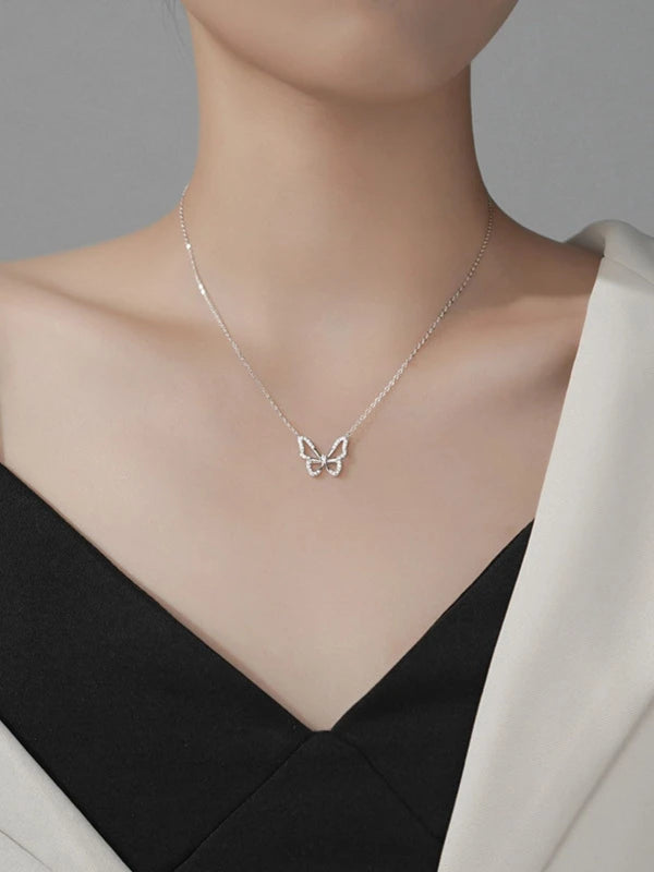 Butterfly necklace on a mannequin with a neutral background