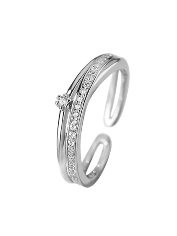 Silver ring with embedded diamonds on a white background