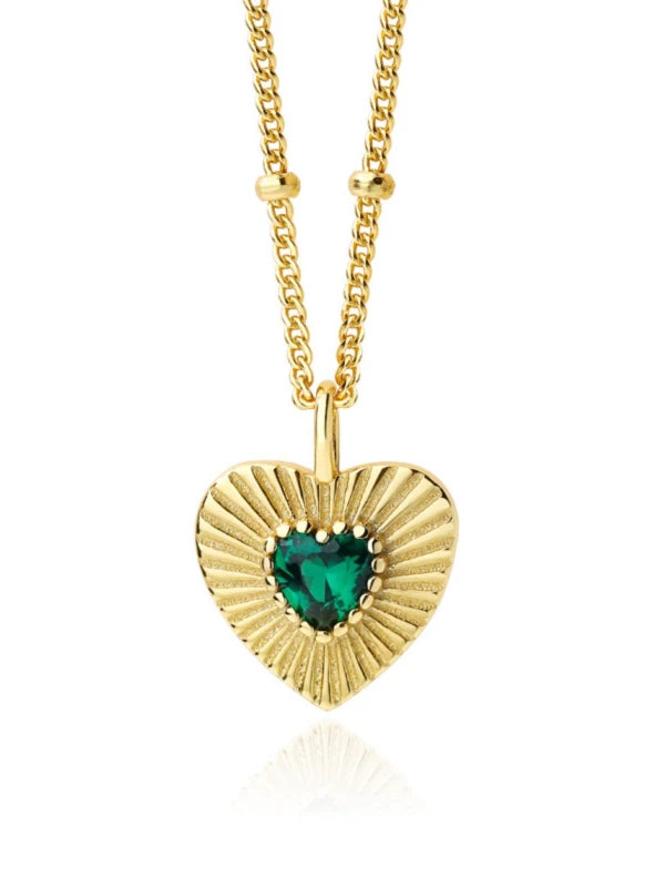 Gold heart-shaped necklace with a green gemstone on a white background