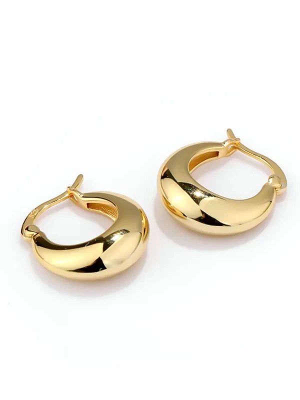 Gold hoop earrings on a white background