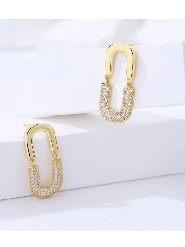 Gold hoop earrings with embedded stones on a white background
