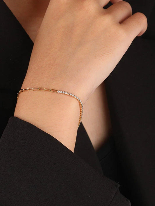 Rose gold bracelet on a wrist against a black background