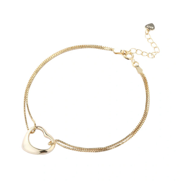 Gold heart-shaped pendant necklace on a white background