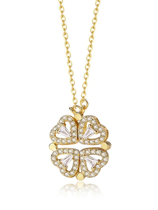 Gold necklace with a clover-shaped pendant on a white background