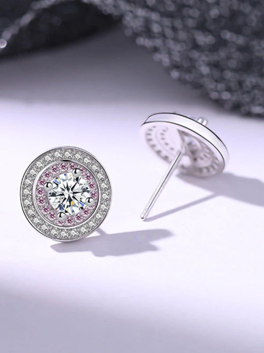 Diamond earrings with pink gemstones on a light background