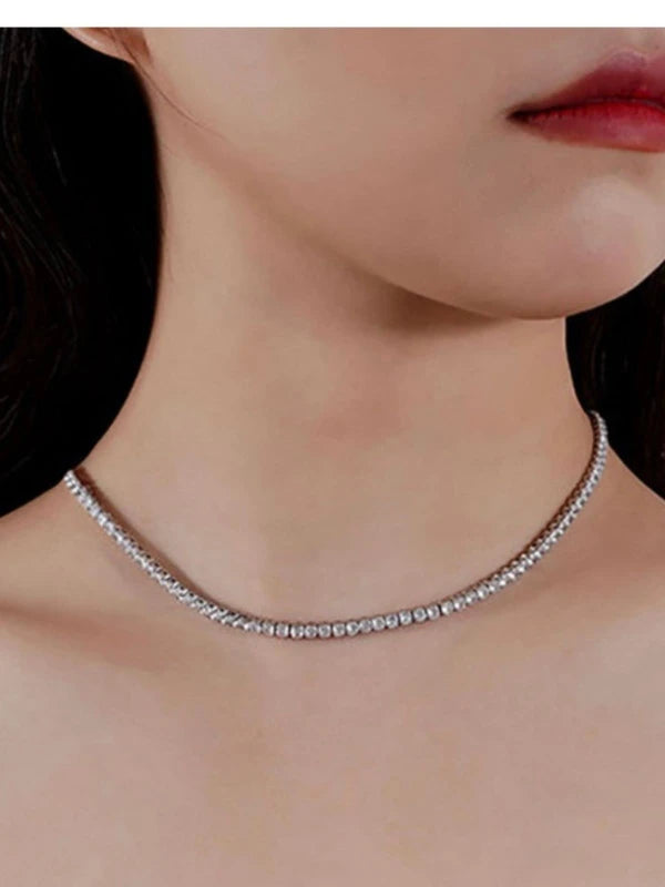 Close-up of a woman wearing a silver necklace