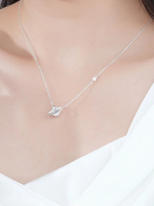 Silver necklace with a pendant on a woman wearing a white top