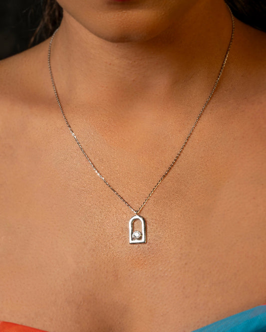 Necklace with a pendant on a person's neck