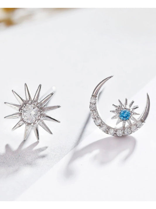 Silver sun and moon earrings with gemstones on a white background