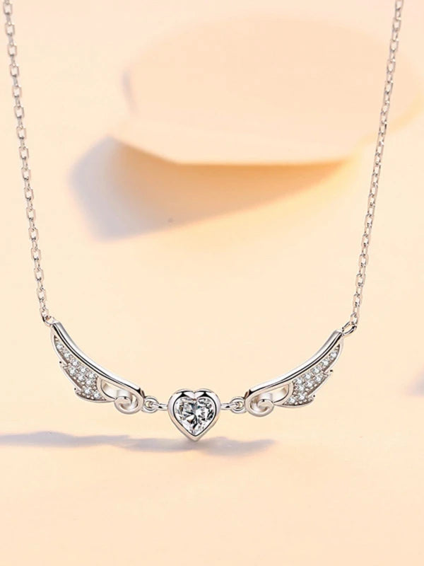 Silver necklace with a heart-shaped pendant on a light background