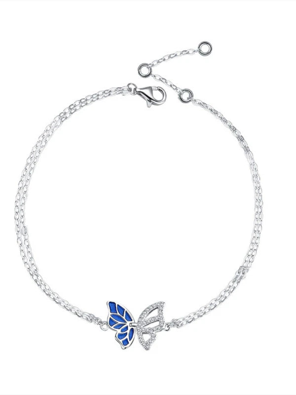 Silver bracelet with a blue butterfly charm on a white background