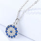 Silver necklace with a blue gemstone pendant on a white background