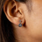 Close-up of an ear wearing a blue and silver earring.