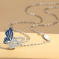 Butterfly-shaped pendant on a chain against a beige background