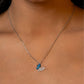 Necklace with a blue butterfly pendant on a woman's neck