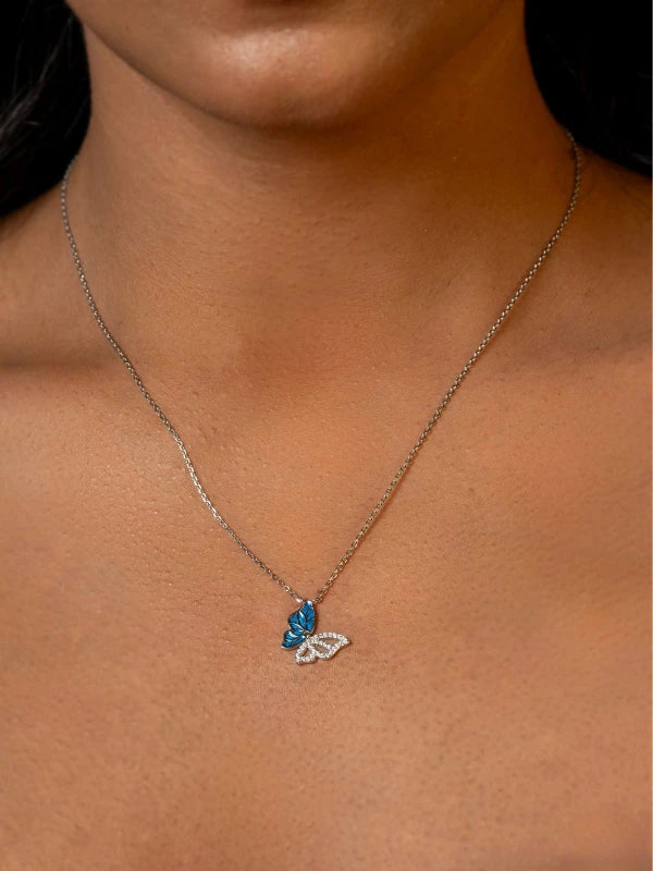 Necklace with a blue butterfly pendant on a woman's neck