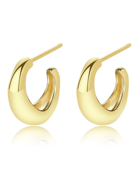 Gold hoop earrings on a white background