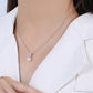 Pearl necklace being worn by a person in a white outfit