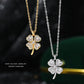 Gold and silver four-leaf clover pendants on dark background