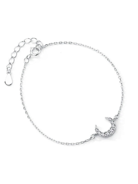 Silver bracelet with a moon design on a white background