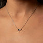 Necklace with a small pendant on a person's neck