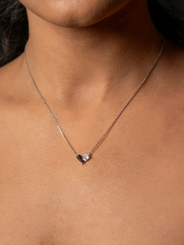Necklace with a small pendant on a person's neck
