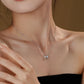 Necklace with a heart pendant worn by a woman against a neutral background