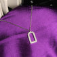 Necklace with a diamond-studded pendant on a purple fabric background