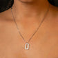 Necklace with a diamond pendant worn by a person