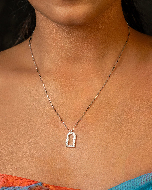 Necklace with a diamond pendant worn by a person
