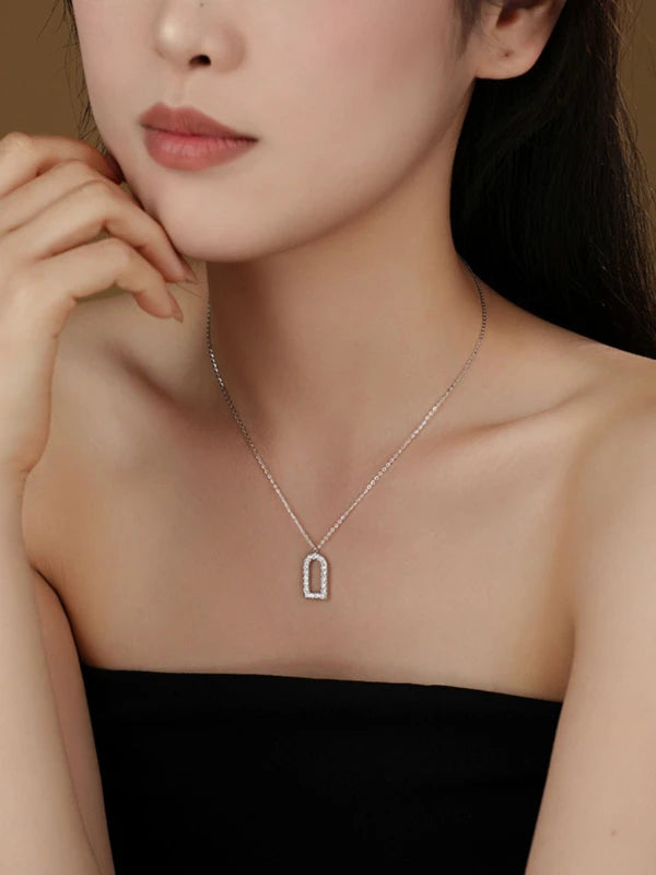 Necklace with a pendant worn by a model against a neutral background