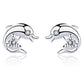 Dolphin-shaped earrings with clear gemstones on a white background
