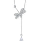 Silver necklace with a dragonfly pendant and teardrop-shaped charm on a white background