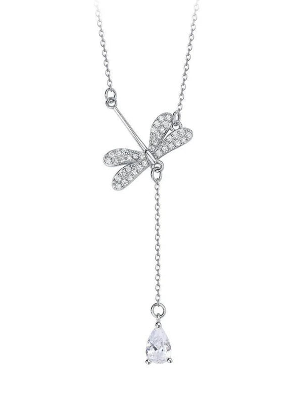 Silver necklace with a dragonfly pendant and teardrop-shaped charm on a white background