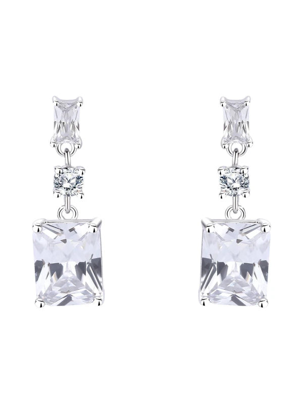 Pair of silver earrings with clear square gemstones on a white background