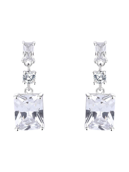 Pair of silver earrings with clear square gemstones on a white background