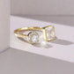 Gold ring with two distinct gemstones on a light background