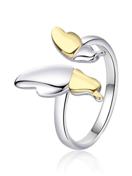 Silver and gold heart-shaped ring on a white background