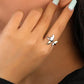 Close-up of a hand wearing a silver ring with a butterfly design.