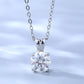 Silver necklace with a clear gemstone pendant on a light blue background