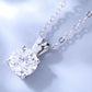 Silver necklace with a clear gemstone pendant on a light blue background