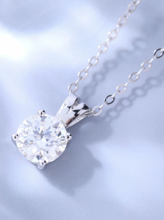 Silver necklace with a clear gemstone pendant on a light blue background
