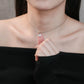 Woman wearing a delicate necklace with a small pendant