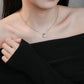 Person wearing a delicate necklace with a small pendant