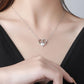 Heart-shaped necklace worn by a person with a blurred background