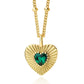 Gold heart-shaped necklace with a green gemstone on a white background