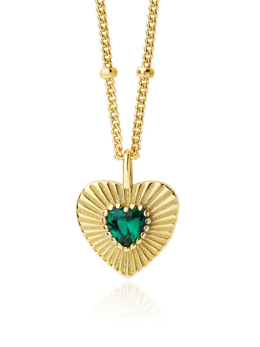 Gold heart-shaped necklace with a green gemstone on a white background