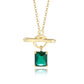 Gold necklace with a green gemstone pendant on a white background