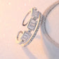 Silver ring with baguette cut diamonds on a soft pink background